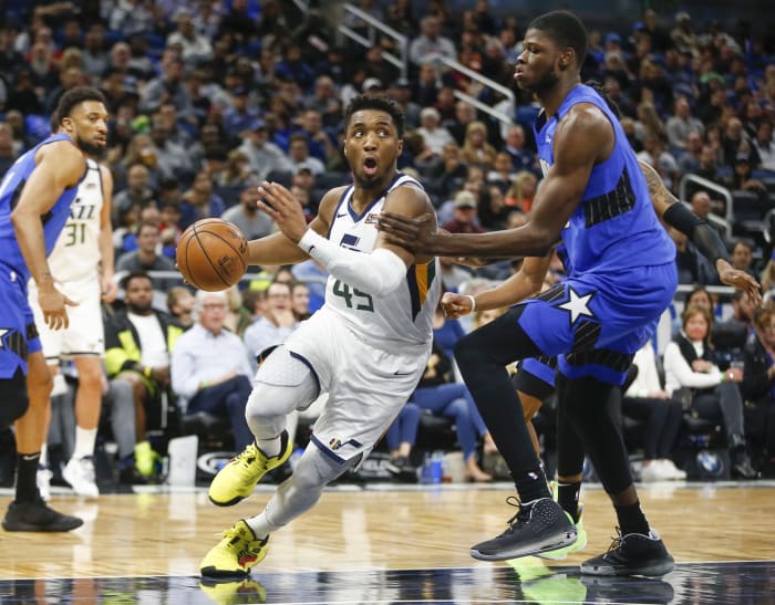 Donovan Mitchell (45) drives past Mo Bamba (5) on his way to the hoop
